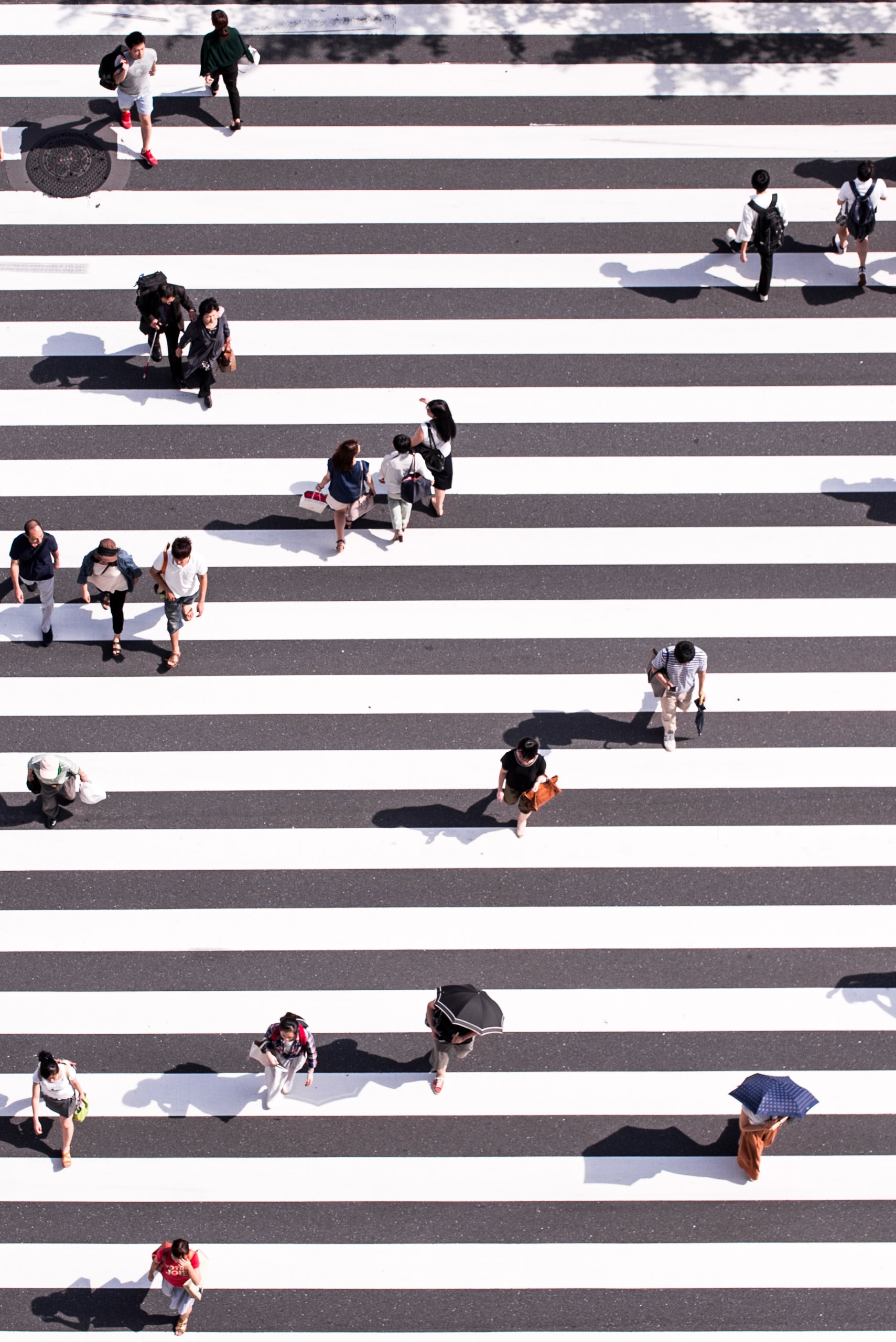 Sky view of residents walking down the street on a sunny day